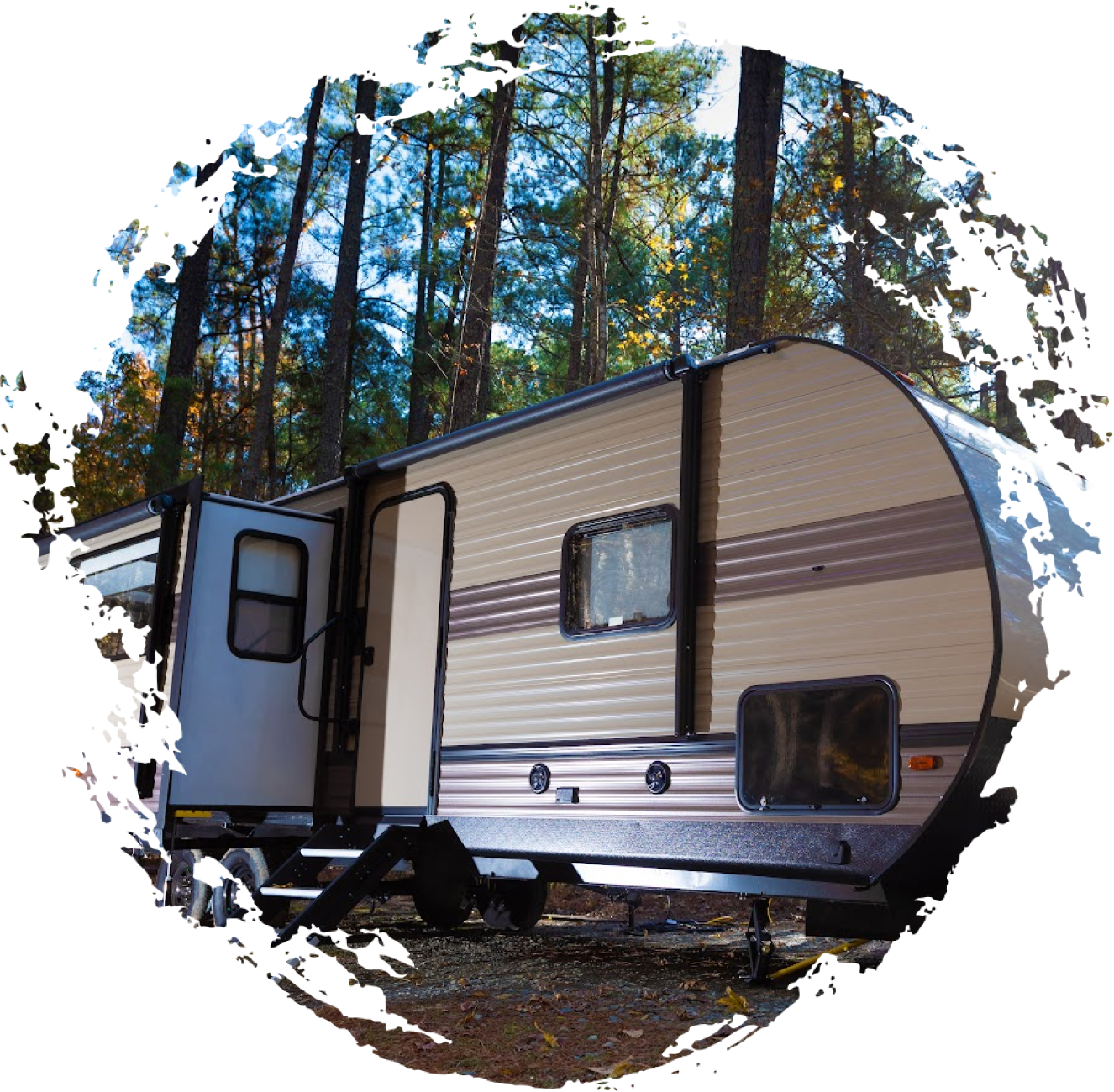 Travel trailer parked in woods.
